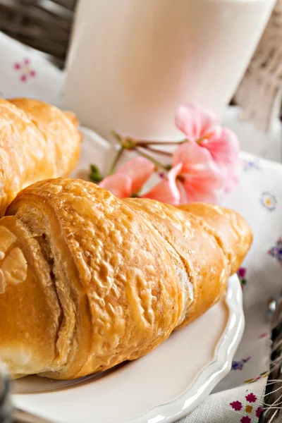 Croissants, coffee cup, flower in romantic style on a wicker tra — Stock Photo, Image