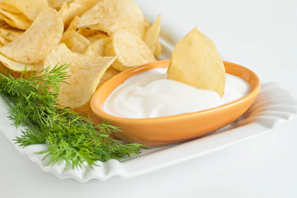 stock image chips with sour cream and dill sauce isolated