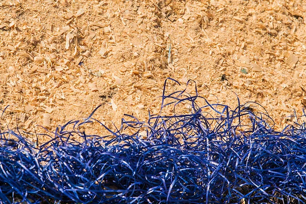 Background of yellow decorative blue sisal and sawdust — Stock Photo, Image