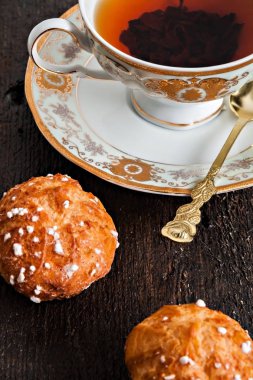 şeker ve bir dar çay ile vintage Kupası ile tepesinde profiterol