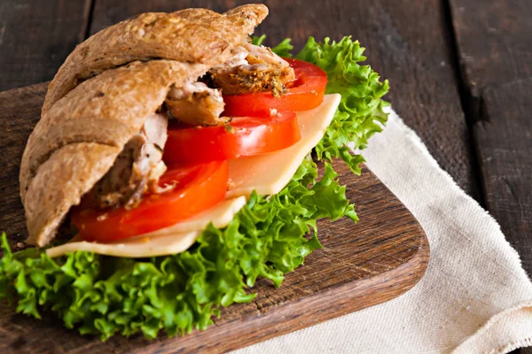 Grain croissant sandwich on a whiteboard and a dark background — Stock Photo, Image