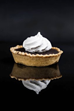 Bir siyah arka plan Isola üzerinde beze tartı ile çikolatalı kek