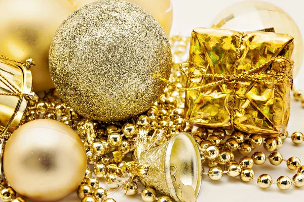 Christmas gold decoration, balls, beads, bell close up isolated