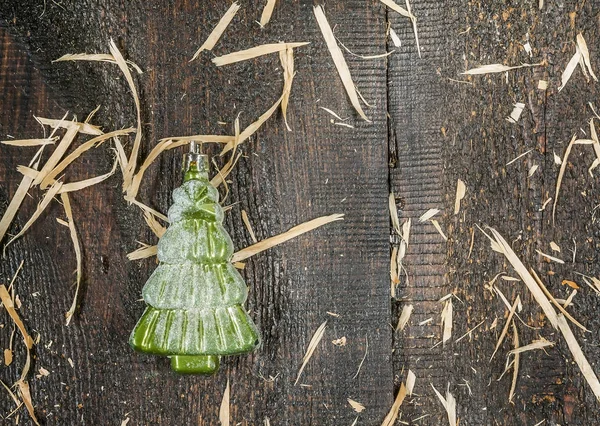 Jouet sapin de Noël en verre en forme d'épinette de neige sur un bois — Photo