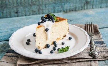 Süzme peynir pişmiş puding, ekşi krema ve yaban mersini 