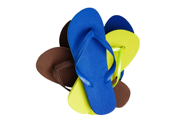 A stack of several pairs of multi-colored rubber flip-flops, iso — Stock Photo, Image