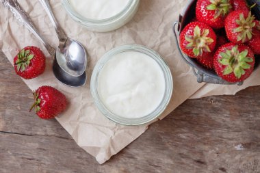 Bir bardak ve bir kova ile taze stra çileklerini yoğurt