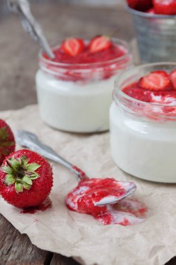 Yoğurt cam ve taze strawberrie bir kova reçel soslu