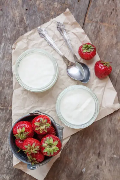 Bir bardak ve bir kova ile taze stra çileklerini yoğurt