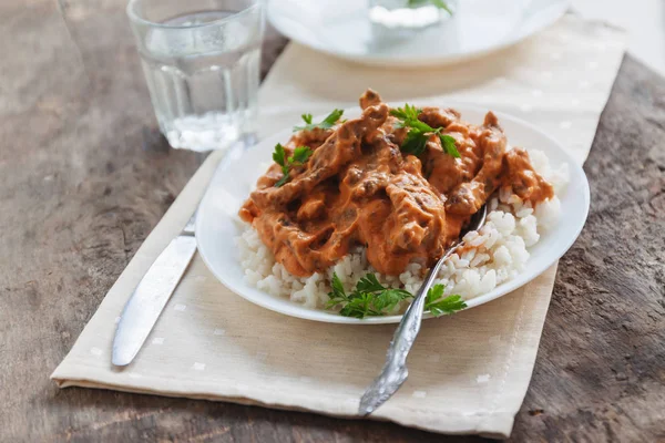 Dish rice with beef stroganoff on a white plate — Stock Photo, Image