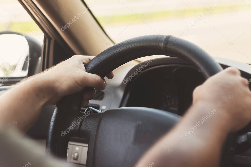 man's hands on the steering wheel retro toning car