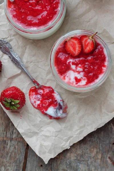 Yogurt with jam sauce in glass and a bucket with fresh strawberr — Stock Photo, Image
