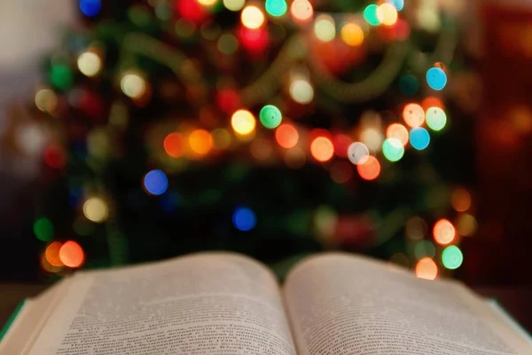 Christmas and bible with blurred candles light background — Stock Photo, Image