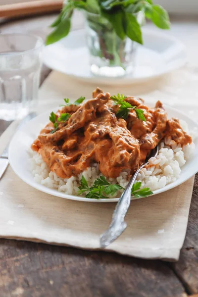 Piring nasi dengan daging sapi stroganoff di piring putih — Stok Foto