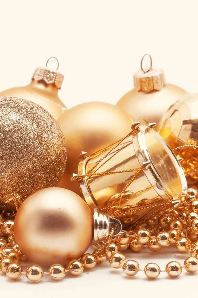 Christmas gold decoration, balls, beads, bell close up isolated