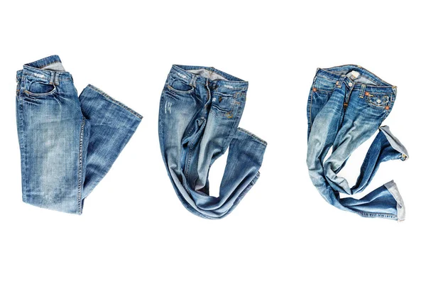 Collectie van gevouwen jeans geïsoleerd op witte achtergrond — Stockfoto