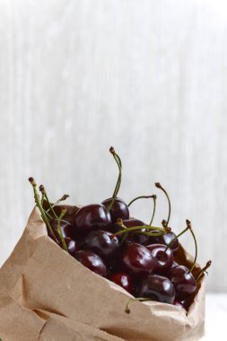 Taze kiraz çilek üzerinde beyaz bir backgro izole bir kağıt torba