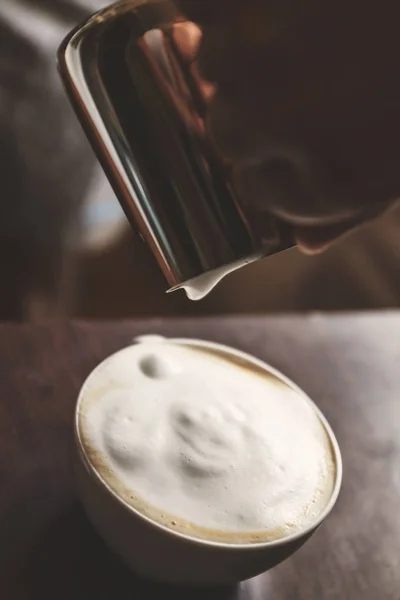 Homme verser dans une tasse de café avec du lait — Photo