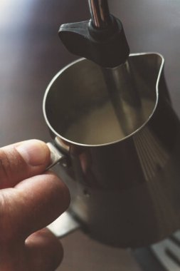 Profesyonel barmen süt kapuçino için Isınma. Barista birimi