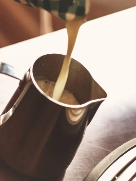 Barista χύνοντας γάλα σε σε κανάτα. Ο άνθρωπος προετοιμασία γάλα και καφέ — Φωτογραφία Αρχείου