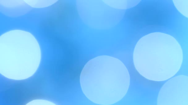 Flashing festive blue-aquamarine lights in bokeh blur. Fixated. Concept, Christmas and New Year celebration. — Stock Video