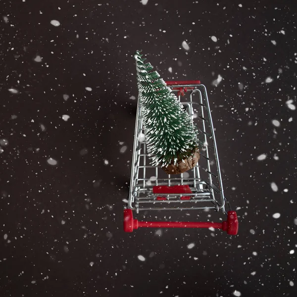 Vue de dessus d'un chariot d'épicerie avec des arbres de Noël enneigés sur un fond neigeux foncé avec espace de copie pour le texte. L'appartement mentait. Hiver, modèle de carte postale . — Photo