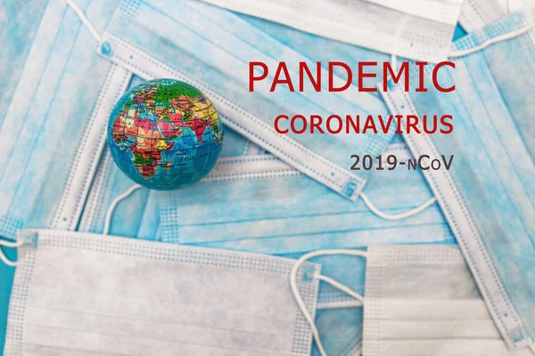 world earth and masks to combat the corona virus with red text PANDEMIC CORONOVIRUS COVID 19 nCoV 19. Concept for the prevention of the corona virus. Climate change concept