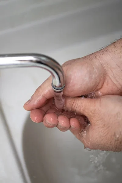Mens hands are showing ways to wash their hands with a cleaning gel to prevent infectious diseases and prevent the virus.