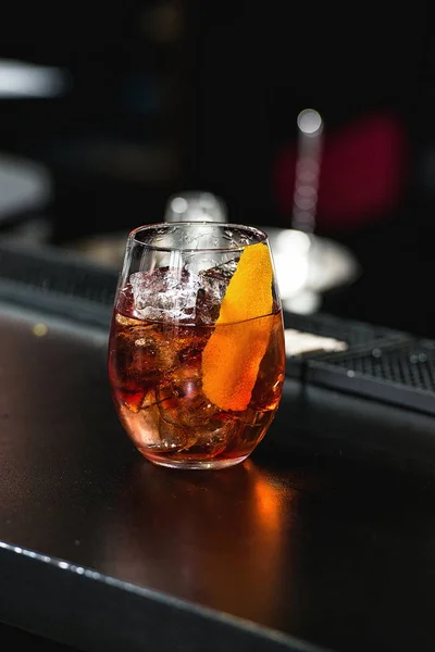 Rode coctail met oranje geïsoleerd op een bar Vernieuwen achtergrond — Stockfoto