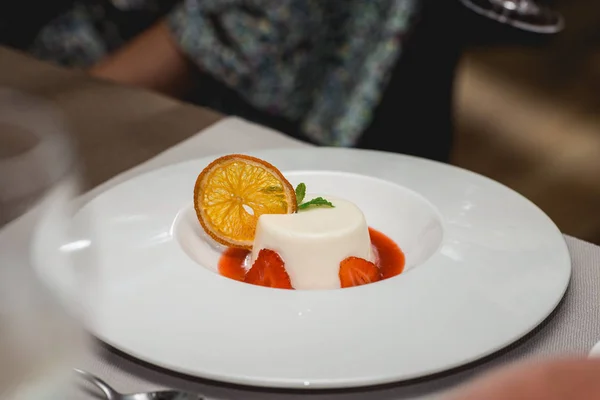 sweet mini dessert with strawberry on a plate in the expensive restaurant. close view