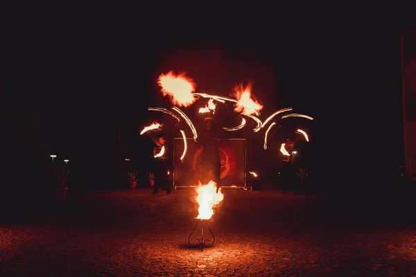 Fire dancing shows at night. Amazing fire show as part of wedding ceremony