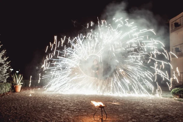 Fire dancing shows at night. Amazing fire show as part of wedding ceremony