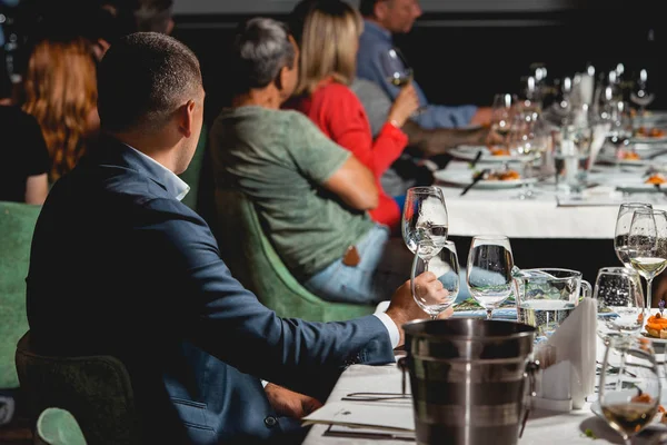 People seats at the Served table for food and wine tasting. Snacks with shrimp, fish fillets, Spain tapas recipe food pintxos