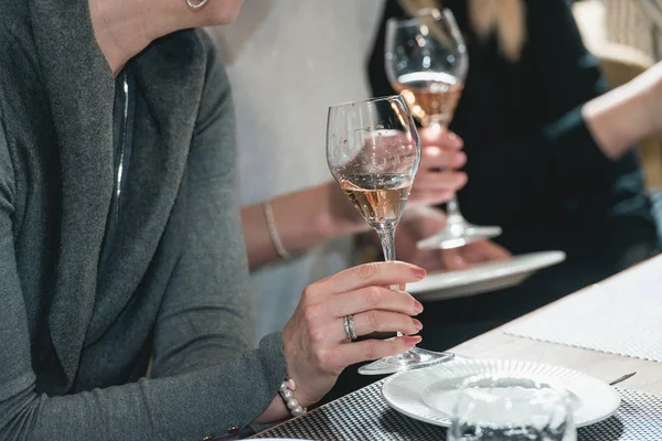 Woman holds glass of red wine. people consider the color of the wine and try how it smells in different glasses — Stock Photo, Image