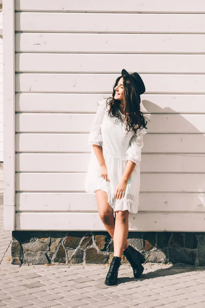 Portrait of young stylish hipster woman , wearing trendy white dress, black hat and boots — 스톡 사진