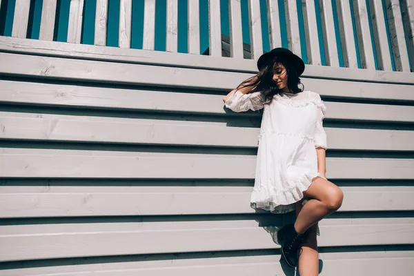 Ritratto solare stile di vita di giovane donna alla moda hipster, indossa abito bianco alla moda, cappello nero e stivali — Foto Stock