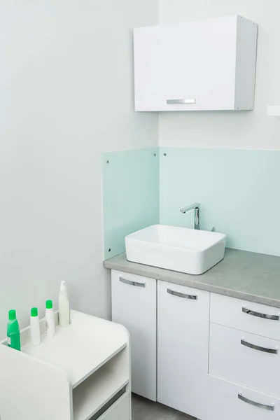 white clean sink in the medical center cabinet