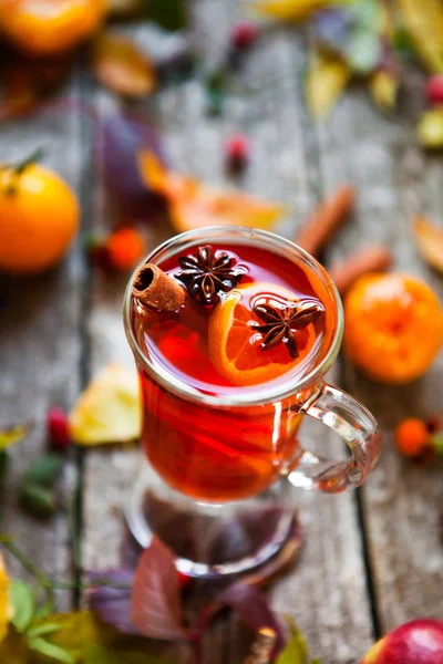 Mulled wine in mugs, spice and dry flowers and leaves. Autumn st