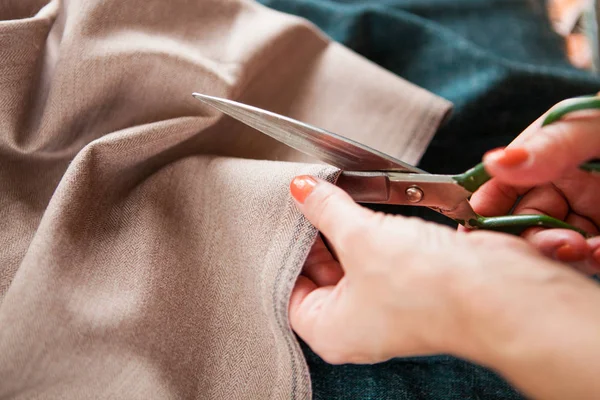 Tailor. Hands notch tailor tailor's scissors cloth. Close Up.