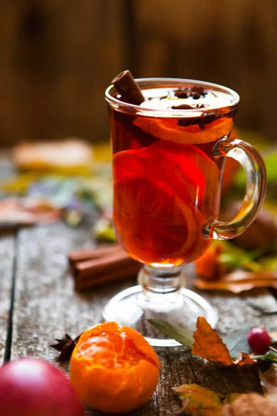 Mulled wine in mugs, spice and dry flowers and leaves. Autumn st