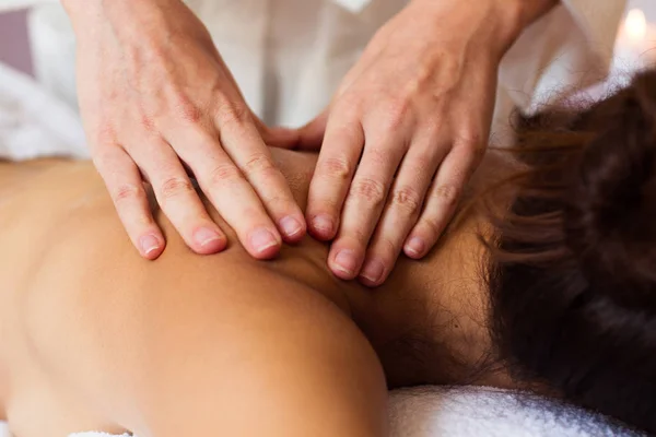 Beautiful young woman relaxing with hand massage at beauty spa. — Stock Photo, Image