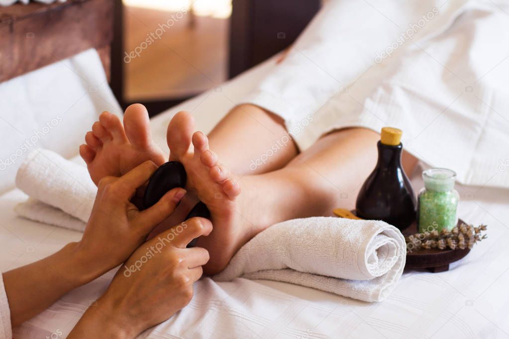 Massage of human foot in spa salon - Soft focus