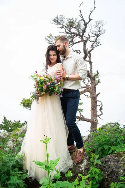 Happy young couple in love outdoors. Beautiful mountains view. L