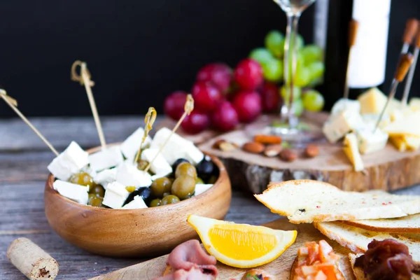 Vaso con vino blanco, uva, queso, sobre fondo rústico de madera — Foto de Stock