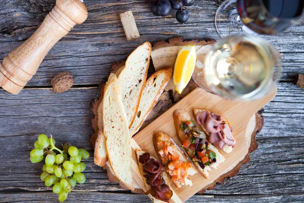 Wine snack set. Glass of red and white wine, grape, cheese, over