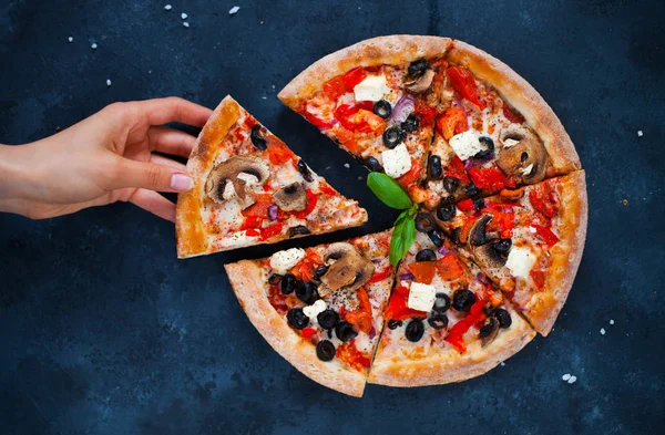 Female hand holds a slice of hot pizza — Stock Photo, Image