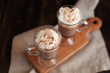 Sıcak çikolata ile süslenmiş çırpılmış krema ve kakao tozu.