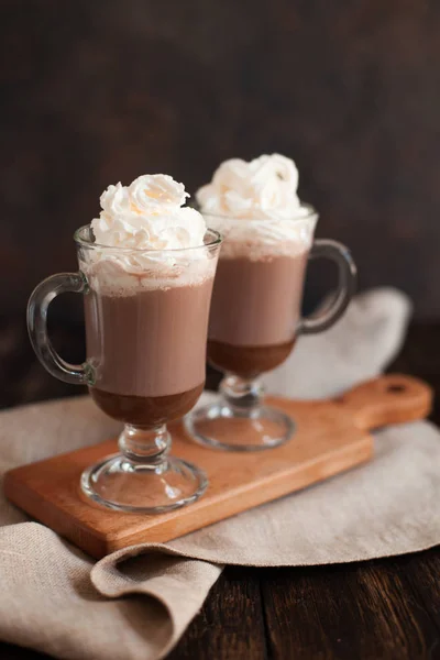 Chocolate caliente adornado con crema batida y cacao en polvo . — Foto de Stock