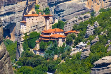 Mountain scenery with Meteora rocks and Roussanou Monastery, landscape place of monasteries on the rock. clipart