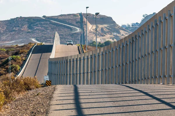 US-Grenzschutzfahrzeug nähert sich der US / mexikanischen Grenzmauer — Stockfoto